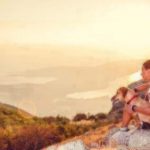 Person and dog enjoying view of mountains