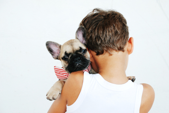 boy holding dog