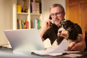 Man budgeting with dog