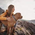 woman on mountain with dog