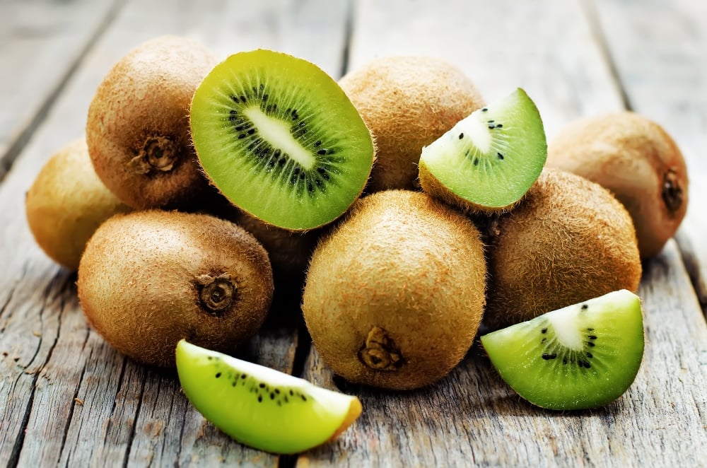 pile of kiwi fruits on a wood table