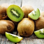 pile of kiwi fruits on a wood table