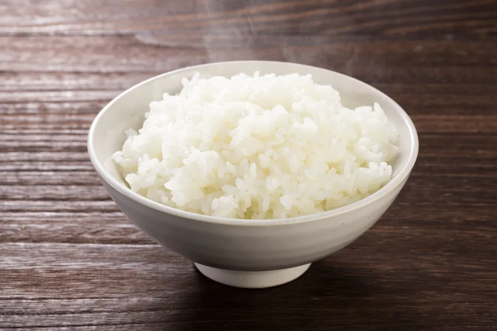 bowl of steamy rice on table