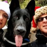 Baron, a black shepherd, with his pet parents.