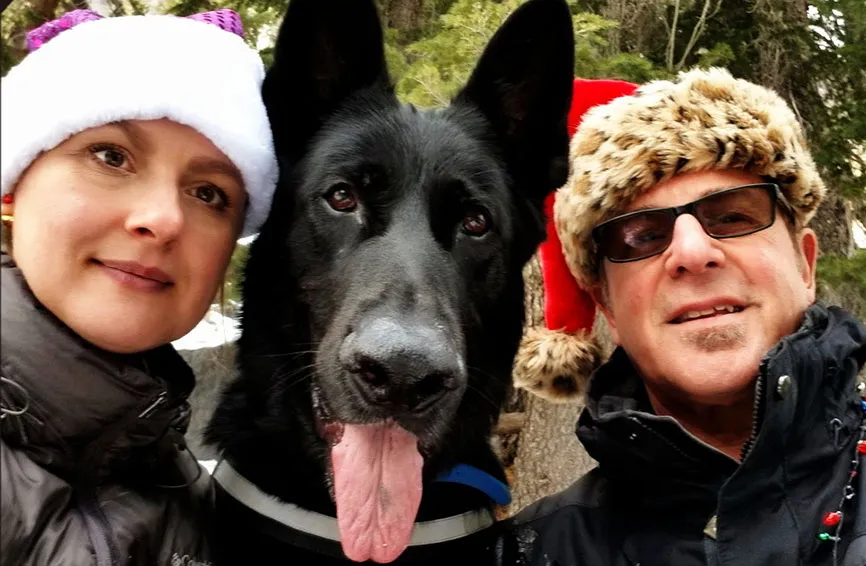 Baron, a black shepherd, with his pet parents.