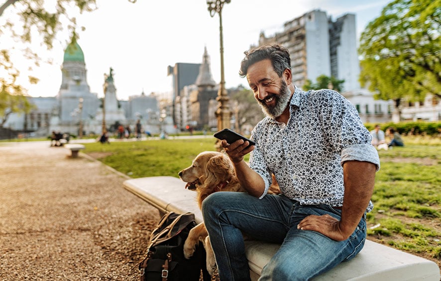 Man at a city park with his dog.